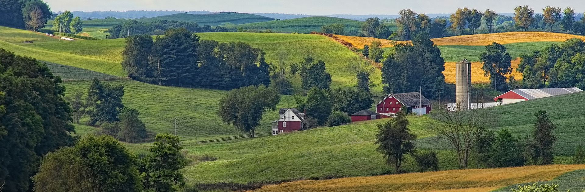 landscape photo of farmland and farmhouse and barn
